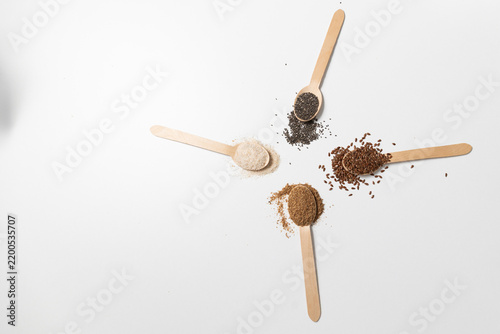 Dietary fiber ingredients arranged on a white studio surface with seeds and powders