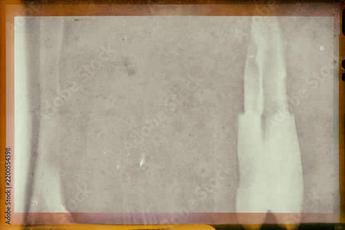 Blank grained film strip texture background with heavy grain, dust and scratches. Photo frame mock up. High resolution and handmade vintage frame
