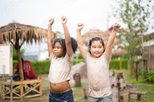 Fotografie Two joyful children celebrate in nature, expressing enthusiasm and friendship, showcasing youthful energy and happiness in a vibrant outdoor setting