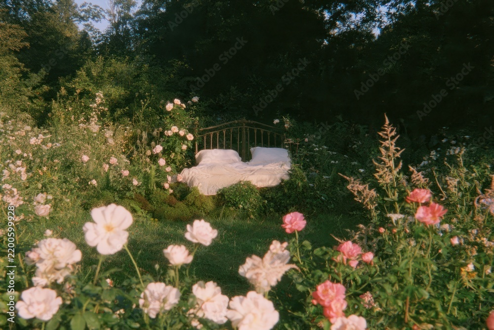 Obraz premium Dreamy garden bed surrounded by blooming flowers in soft light