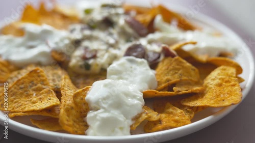 Loaded nachos with melted mozzarella cheese and tender beef close-up