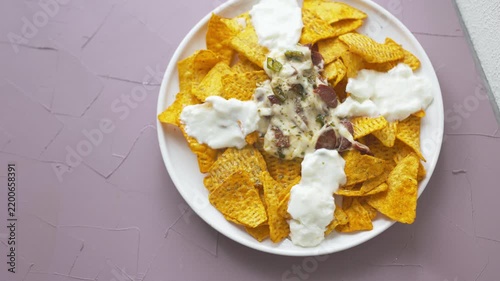 Loaded nachos with melted mozzarella cheese and tender beef close-up