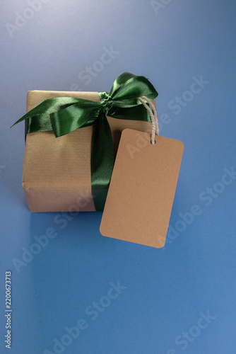 a mock-up of a gift with a green bow and a blank brown label