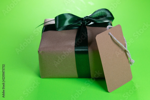 a mock-up of a gift with a green bow and a blank brown label