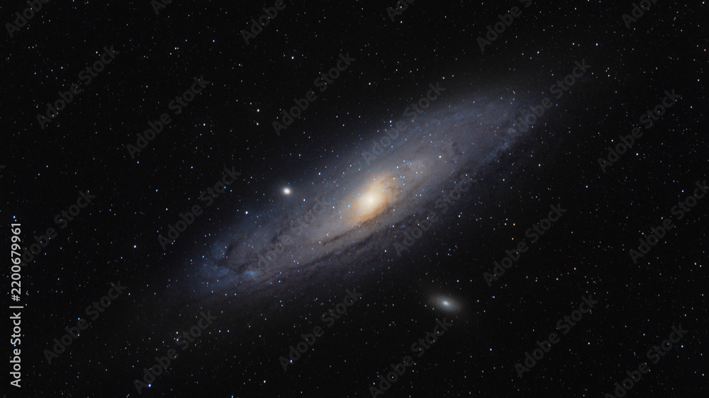 Fototapeta premium The Andromeda Galaxy Messier 31, the nearest large spiral galaxy to the Milky Way, with its bright core, dust lanes and satellite galaxies M32 and M110