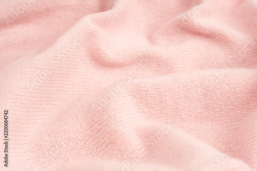 Soft pink cashmere sweater texture background.