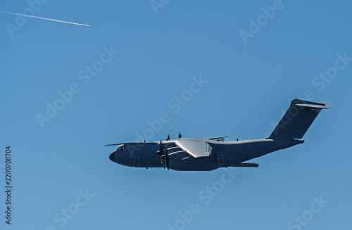 Canvas Print Airbus A400M Atlas military transport airplane flying across a clear blue sky, d