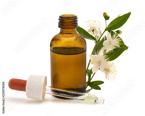 Myrtle flowers with dropper bottle and pipette isolated on white
