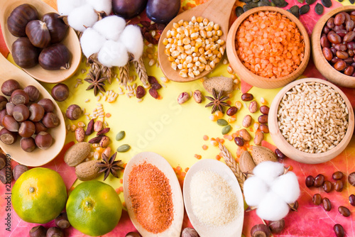 Designed a harvest frame on yellow surface with natural,dried foods.Blank space for text on center of image.	