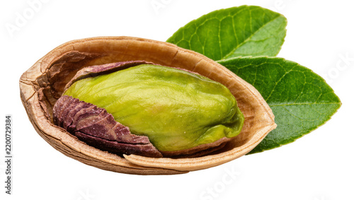 Single pistachio nut with shell and green leaves, isolated on transparent background