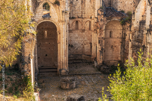 Gothic monastery ruins interior with stone arches and apse