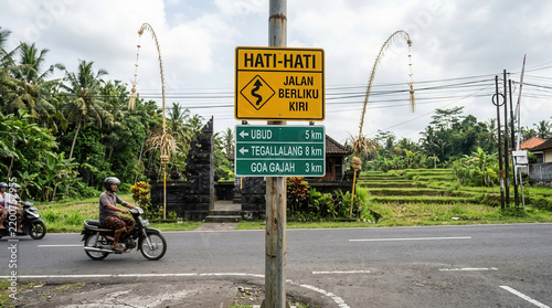 Tropical Road Signage And Scenic Rice Terraces With Motorbike Traffic