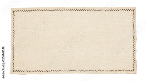 Rectangular beige canvas fabric patch with dark stitched edges isolated on white