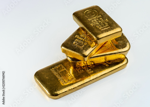 Several gold bars of different weight isolated on white background.