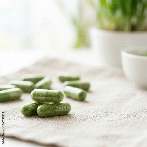 Healthy Green Supplements On A Natural Fabric Surface
