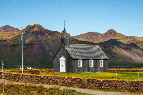 Búðakirkja or Black church of Budir, old wooden church, with white door, windows and gate and was established in 1703. Búðir, Snæfellsnes Peninsula. One of the most photographed churches in Iceland.