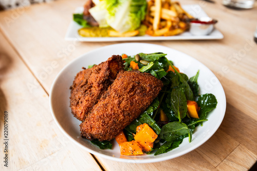 Healthy and flavorful fall salad with crispy gluten free chicken from a popular wine bar and restaurant.