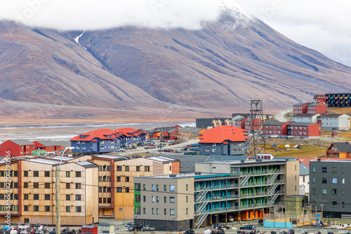 Modern residential buildings and colorful urban district with dramatic Arctic mountains in Longyearbyen, Svalbard, Norway