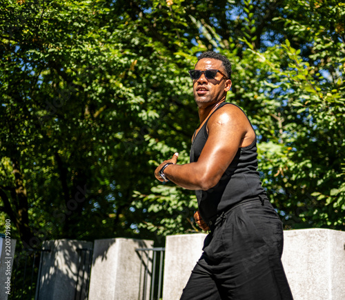 Obraz na płótnie Black man dancing energetically in nature, portraying Latin dance culture, expre
