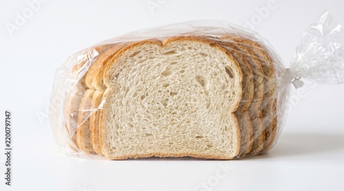 A single slice of soft white bread standing prominently before a packaged loaf on a bright studio backdrop.