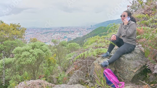 Woman Hiking on Mountain Overlooking City While Talking on Phone, Outdoor Nature Break