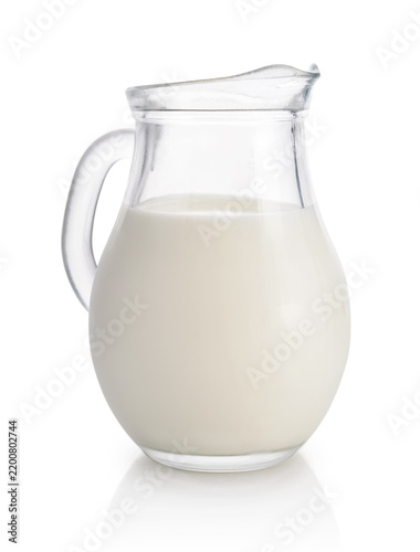 Milk in a glass pitcher isolated on a white