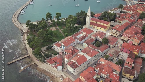 Aerial view of St Pelagius church bell tower breakwater and harbor in Novigrad Istria Croatia