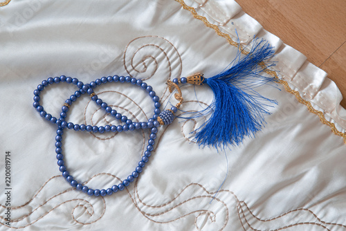 Close up of Prayer Rug And Tasbih Beads