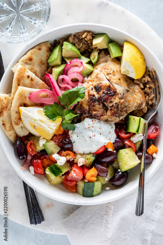 Top down view of a homemade Greek Chicken Bowl with Tzatziki dressing.