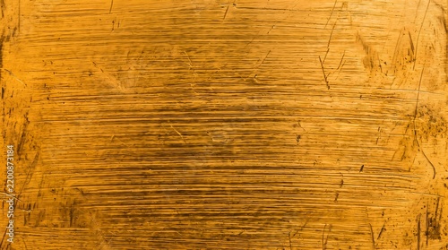 Weathered gold grunge texture with rough distressed pattern, vintage rustic metallic background design.