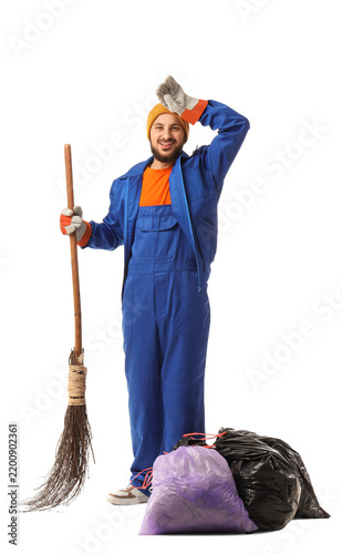 Фотография Male scavenger with broom and garbage bags on white background