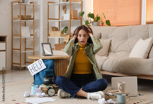 Stressed female student studying at home