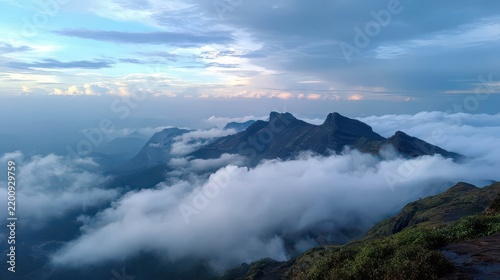 Majestic Mountain Range Surrounded by Clouds at Dusk