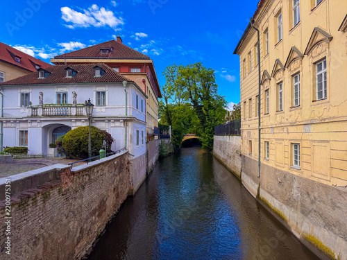 Bild auf Leinwand Canals flow between colorful buildings in Prague