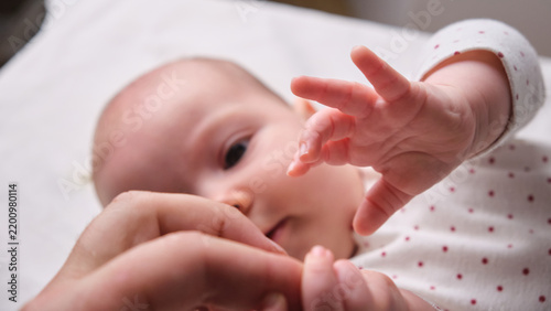 Baby reaching for hand during interaction in a home setting