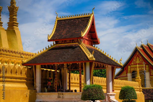 Pha That Luang, Traditional buddhist temple with ornate golden roof and stupa in laos