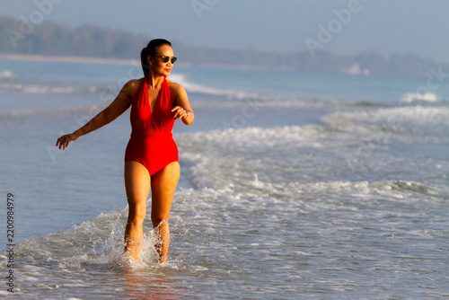 Woman sexy with red swimsuit on beach