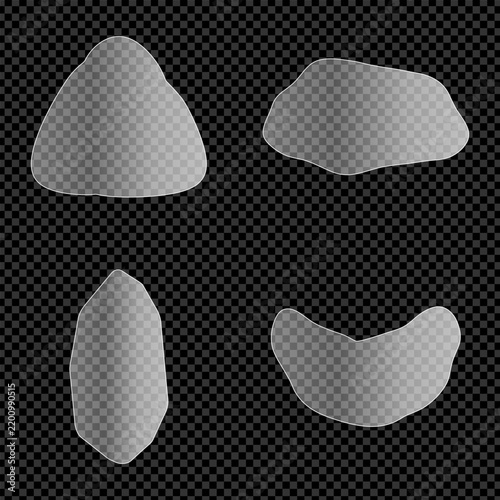 Four gray stones with textured surfaces against a dark dotted background