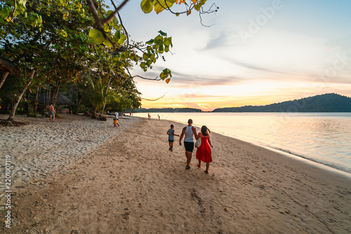 family walking on the beach on Bang Bao beach, Koh Chang island
