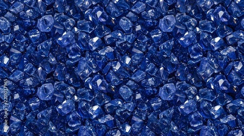Macro view of scattered dark blue glass beads texture.