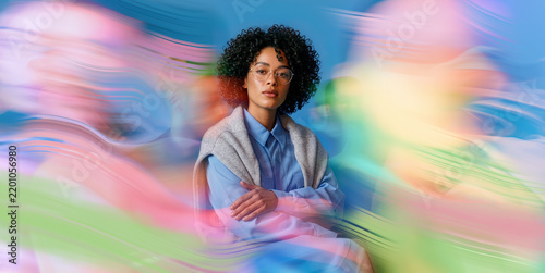 Confident African Woman Surrounded by Blue Pink and Green Artistic Dynamic Blur