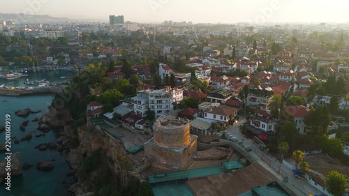 Antalya, Turkey. Hidirlik Tower, a 2nd-century Roman cylindrical stone monument rising from a square base, aerial view at sunrise over the Mediterranean coastline and Kaleici old town. Aerial View, M