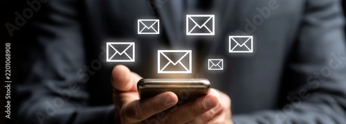 Businessman using smartphone to receive emails with notifications  