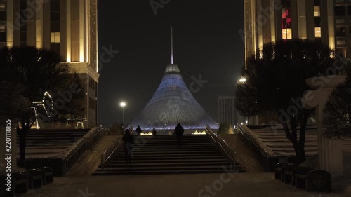 Night view of the Khan Shatyr Entertainment Center illuminated with neon lights in winter. 