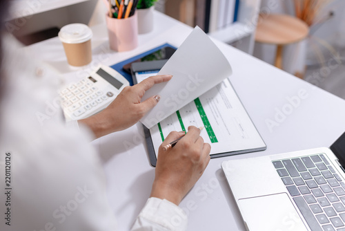 Business professional organizing documents  reviewing information and managing daily office tasks to support efficient workflow  planning and business operations in a modern workplace.