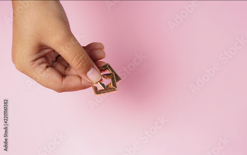Tiny Decorative Object on Pastel Pink Background