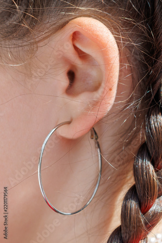 Картината върху платно Close-up of ear with silver hoop earring