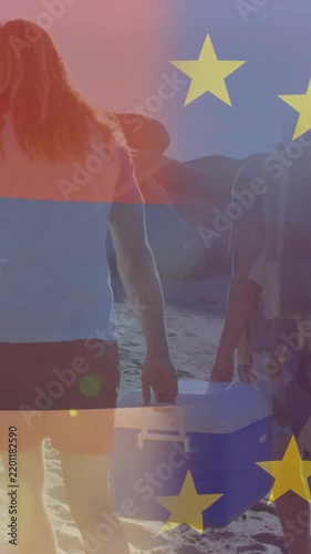 Vertical video: Travel group walking shore to set up spot, cam tracking behind stars overlay moving