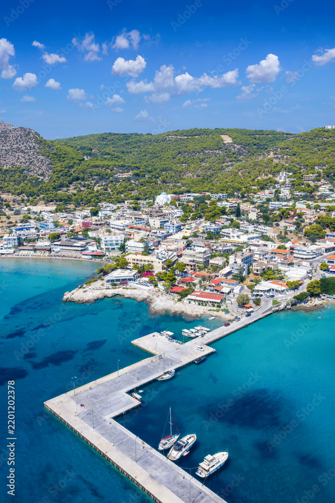 Fototapeta premium Aerial view of the coastal town Agia Marina on the Greek island of Aegina, Saronic Gulf, Greece, during a sunny summer day