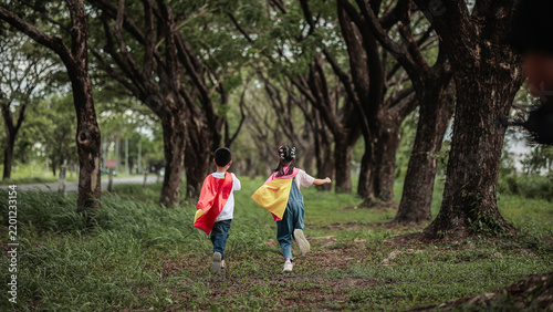Children Running Through Forest Park Wearing Superhero Capes, Imagination, Adventure, Outdoor Play and Happy Childhood